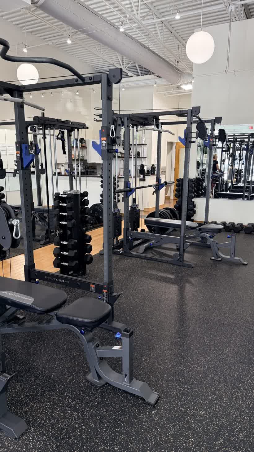 A private training station at PEAKFIT. Studio: your own rack, bench, and dumbbells