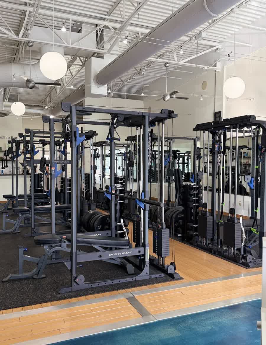 Inside PEAKFIT. Studio: bright private training stations with racks and mirrors